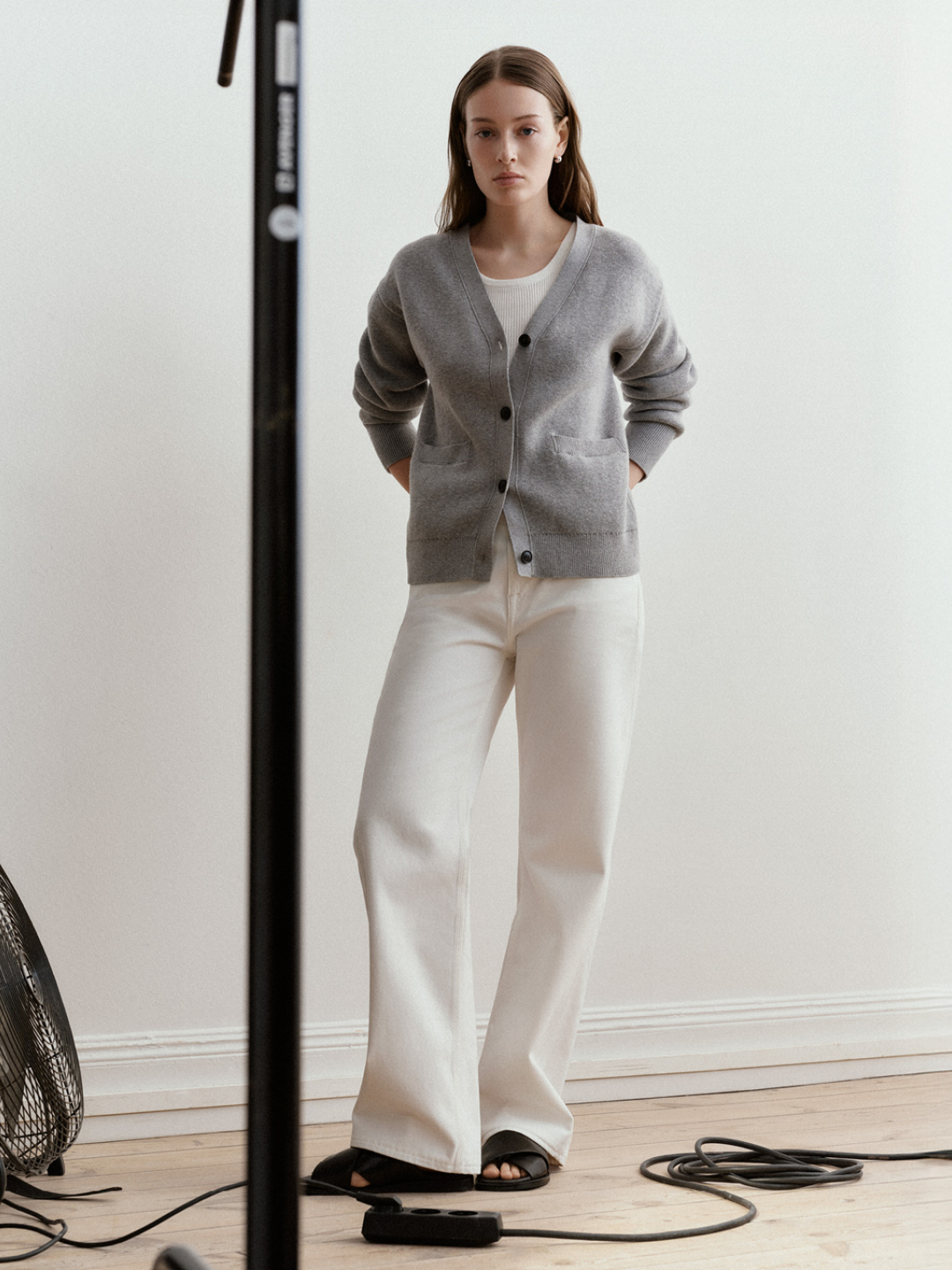 woman in cardigan and white jeans